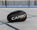 A premium black Carbo Padel racket bag with orange and white branding.